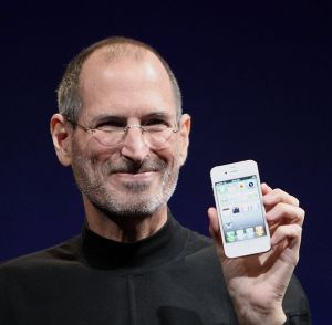 Steve Jobs holding a white iPhone 4 at Worldwide Developers Conference 2010.
