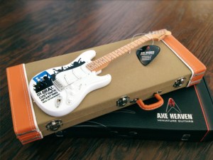 The optional miniature tweed style guitar cases look so real! An optional mini guitar strap is also available to add the final personal-touch-accessory to your personalized package. 