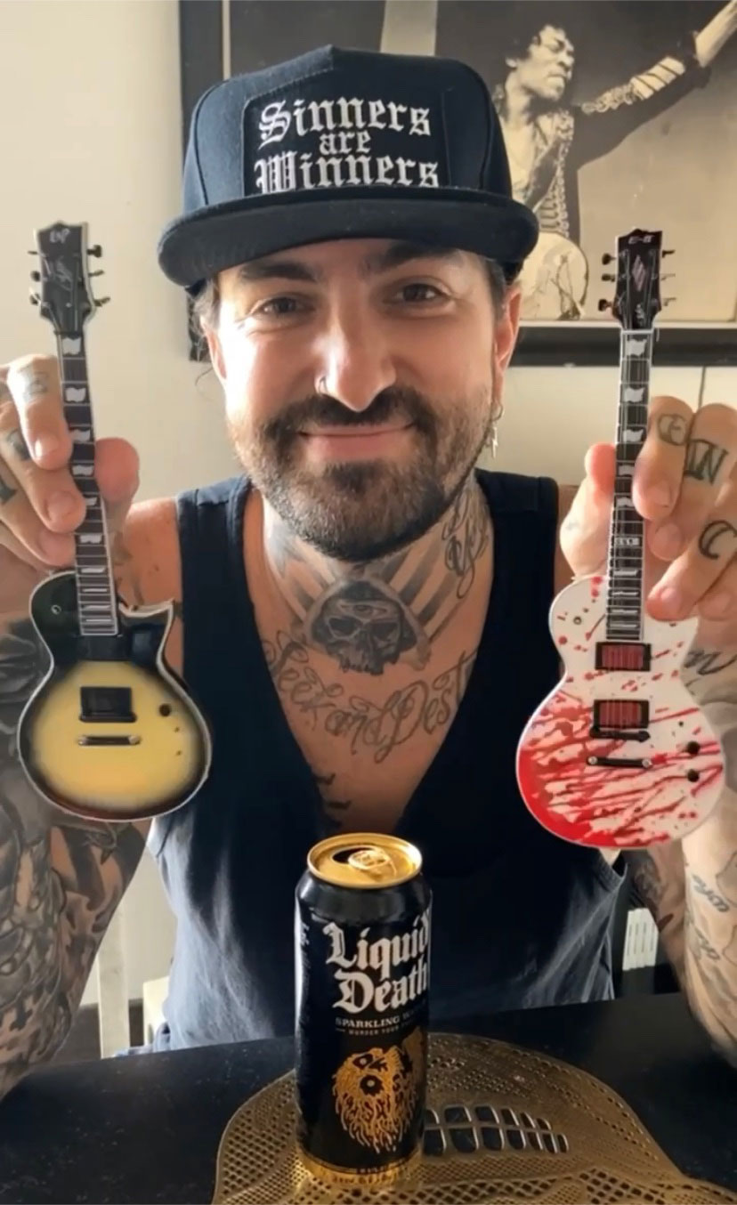 Bobby Keller holds his Black Natural Burst and Blood Splatter ESP Eclipse Mini Guitar Replica Collectibles by AXE HEAVEN®