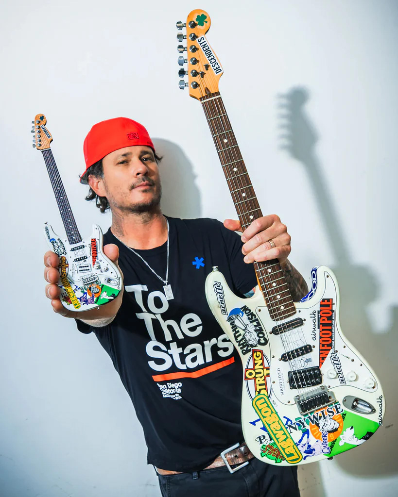 Tom DeLonge Holds DAMMIT Signature Fender™ Guitar and Miniature Guitar Replica Collectible by AXE HEAVEN®